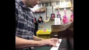 Tom explores the piano at Bur &OpenCurlyQuote;s showcase store